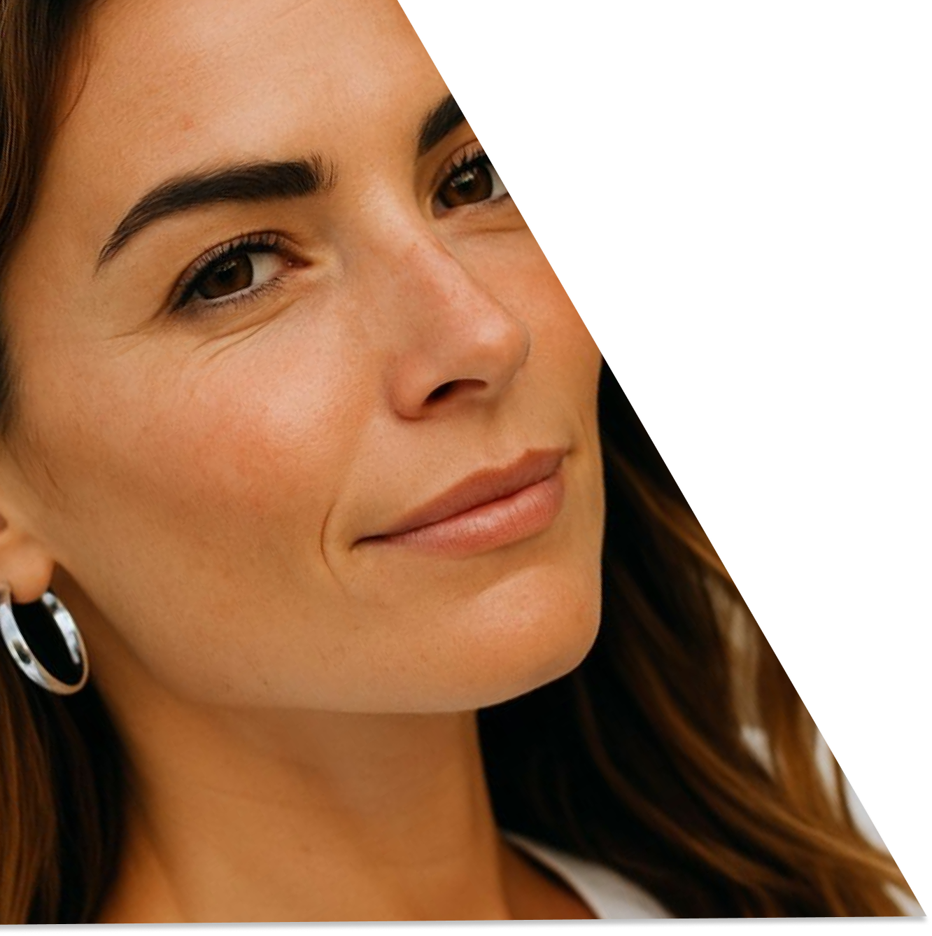 A smiling woman wearing silver earings